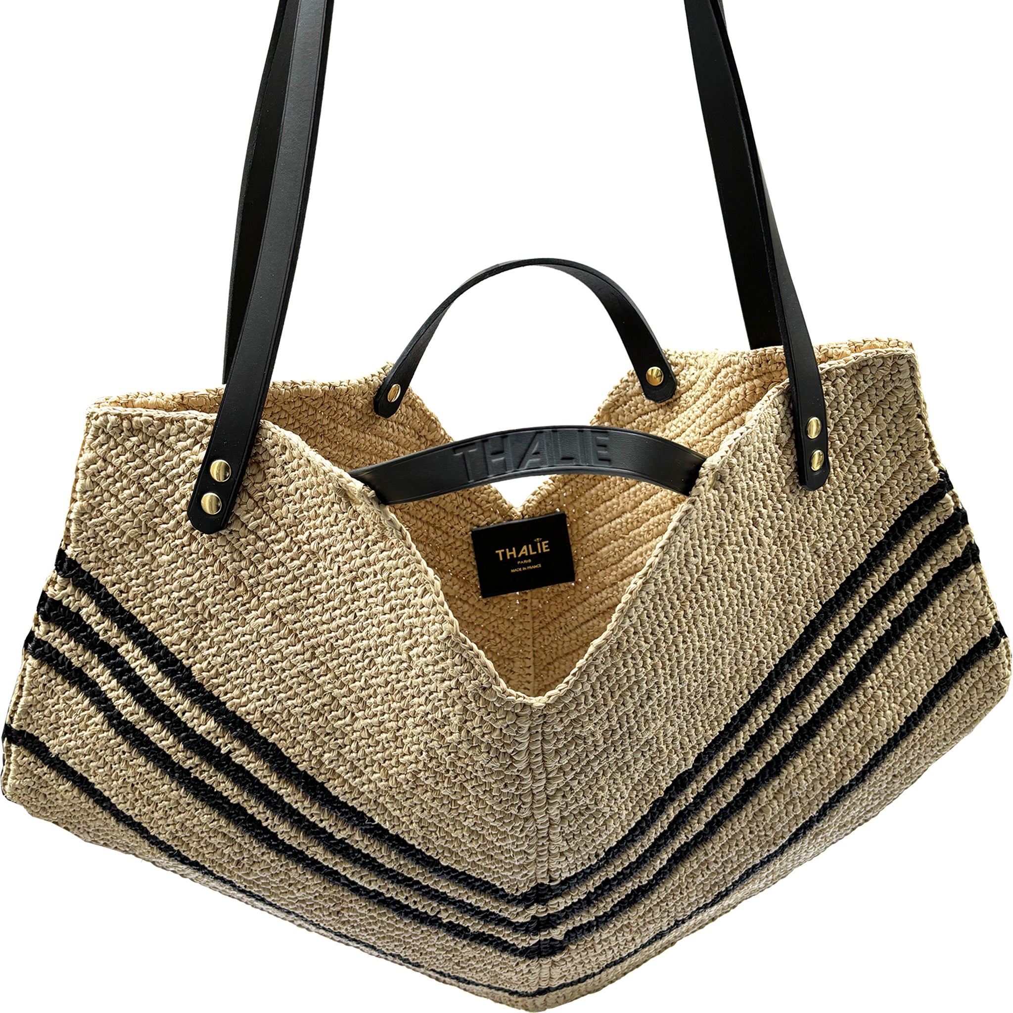 Handwoven black raffia tote with vegetal dyed leather straps.