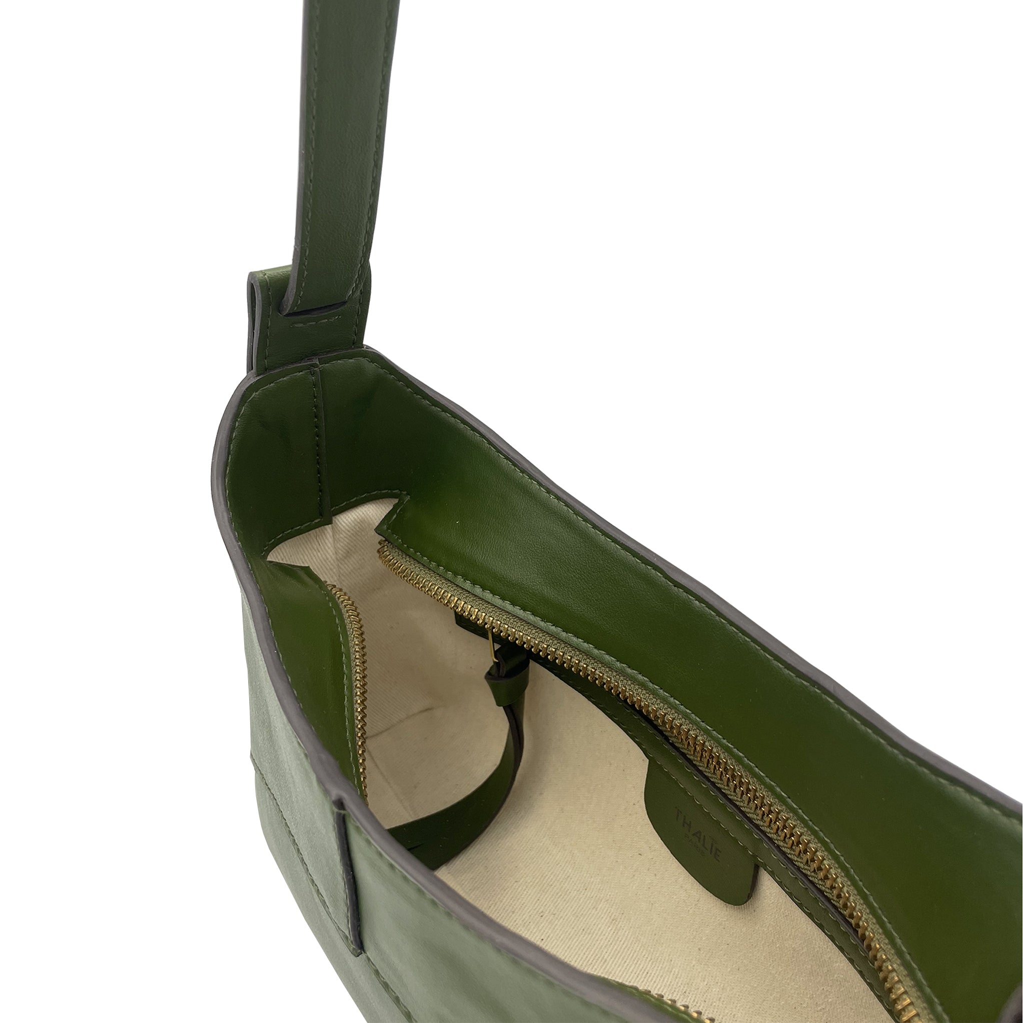 Interior detail of the Ambre cactus green vegan shoulder bag by Thalie Paris, featuring premium cactus leather, gold-tone zipper and natural cotton lining