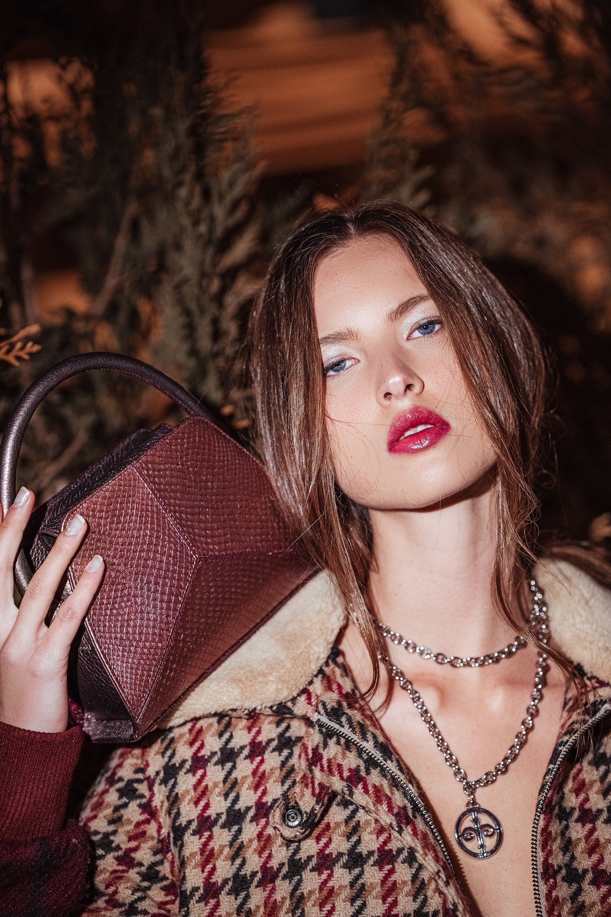 Thalie Paris marine leather handbag made in France, luxury eco-luxury bag crafted from recycled salmon leather, model with burgundy top handle bag.